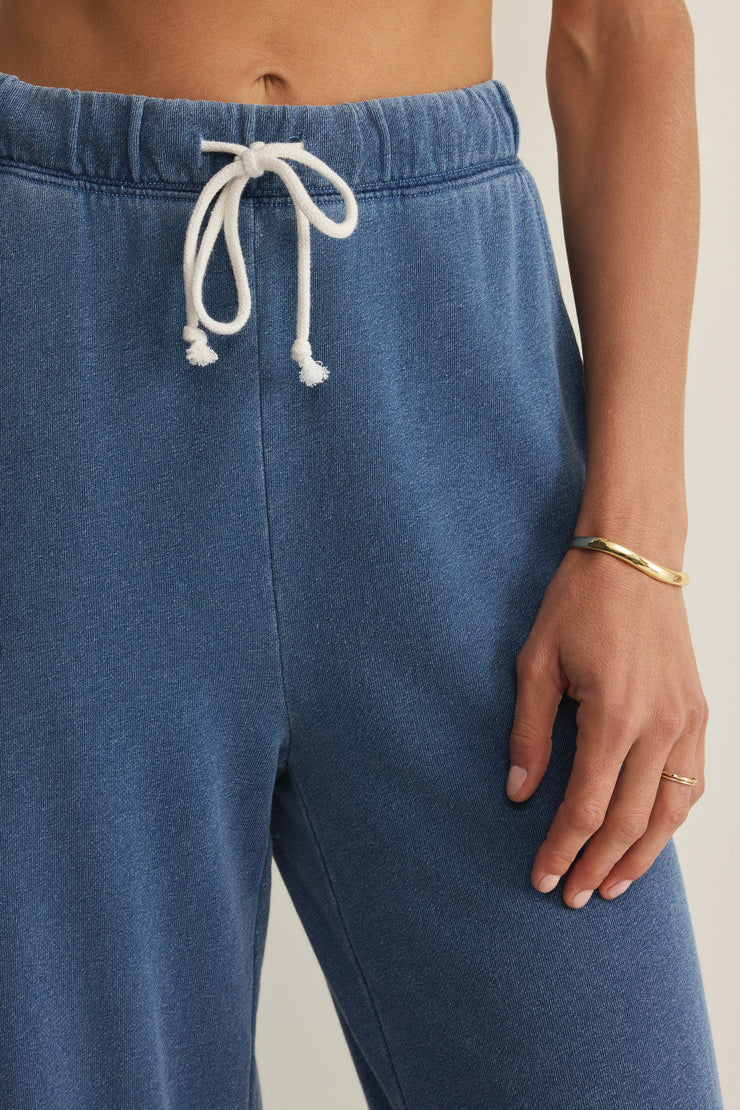 woman wearing blue wide leg lounge pants with a drawstring waist and relaxed fit, drawstring detail
