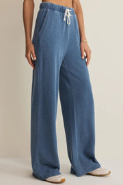 woman wearing blue wide leg lounge pants with a drawstring waist and relaxed fit, side