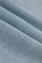 light blue wide leg denim pants with elastic waistband and front pockets, fabric detail view