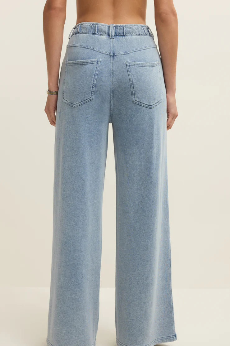 light blue wide leg denim pants with elastic waistband and front pockets, back view
