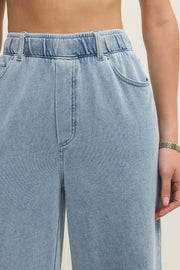 light blue wide leg denim pants with elastic waistband and front pockets, detail view