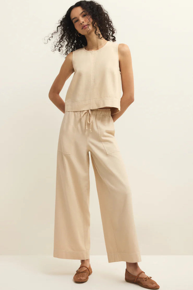 Woman wearing twill beige sleeveless top and wide-leg pants 