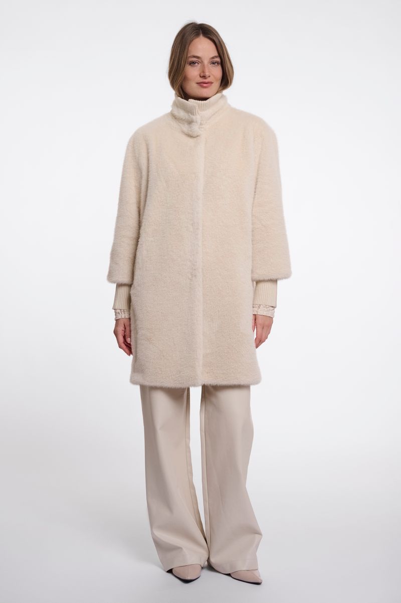 Woman wearing a beige fluffy coat. 