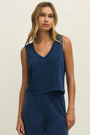 Woman wearing a navy blue denim wash sleeveless v-neck knit tank top with relaxed fit