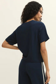 Woman wearing a navy short sleeve knit t-shirt, front view