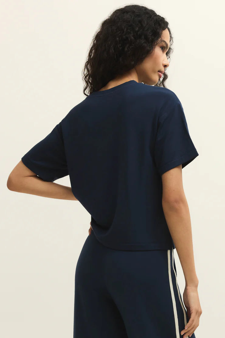 Woman wearing a navy short sleeve knit t-shirt, front view