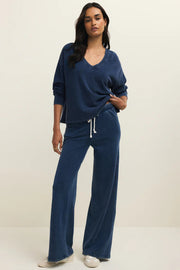 a woman wearing a indigo v neck sweatshirt