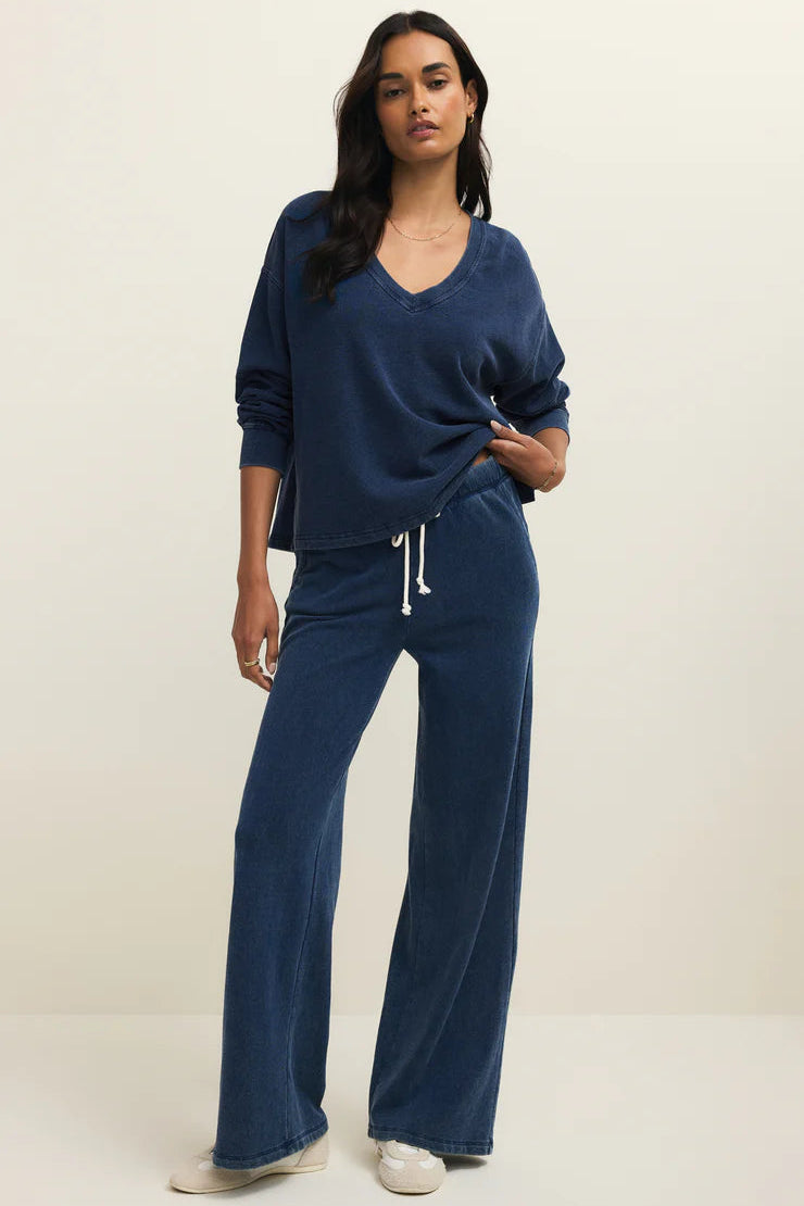 a woman wearing a indigo v neck sweatshirt