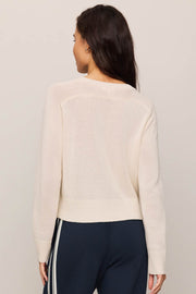 Woman wearing a beige 'GAME DAY' sweater