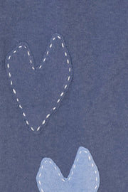 Blue scarf with imperfect heart patches and whipstitch detailing all over