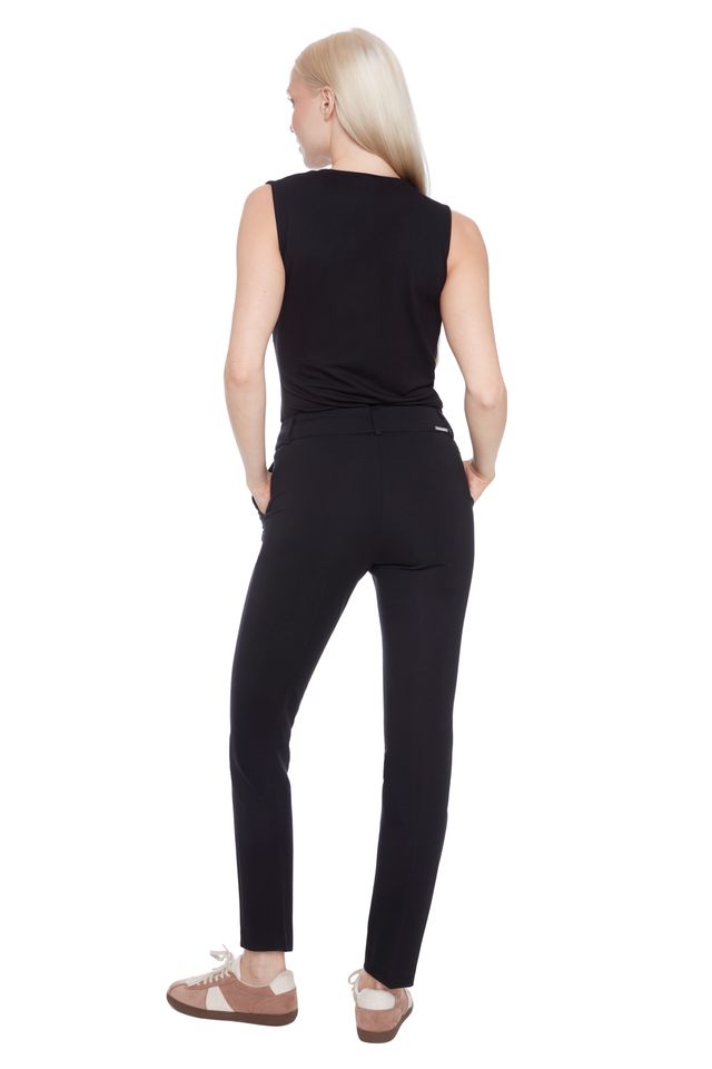 Back view of woman wearing a black sleeveless top and black compression pants 