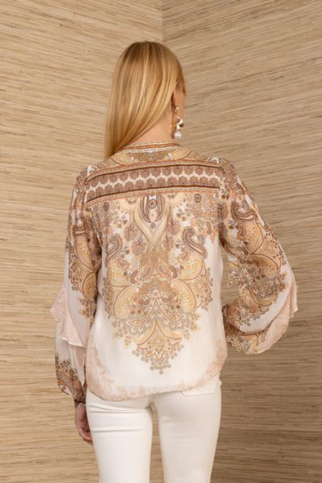 Woman wearing a paisley patterned blouse 