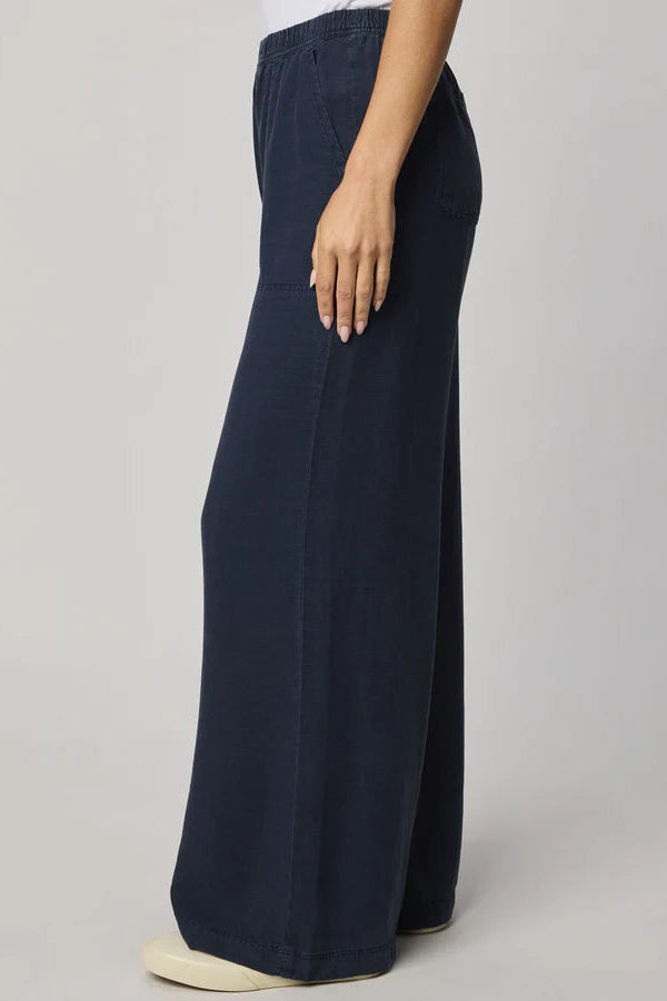 Navy wide-leg pull-on pants with an elastic waistband, side view