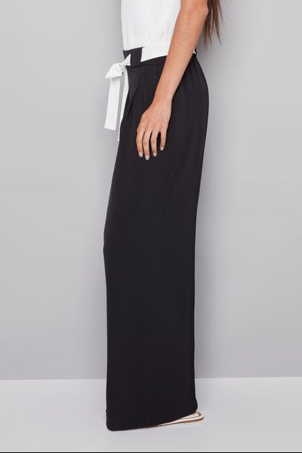 woman wearing a black pat with white shash belt 