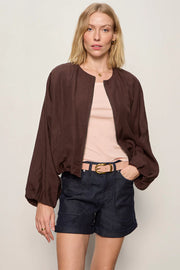 Woman wearing a lightweight rich chocolate brown bomber-style jacket with a relaxed fit. Features a zip-front closure, round neckline, dolman sleeves, elastic cuffs and waistband, and two front slant pockets, front