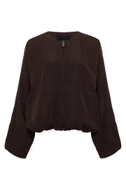 Woman wearing a lightweight rich chocolate brown bomber-style jacket with a relaxed fit. Features a zip-front closure, round neckline, dolman sleeves, elastic cuffs and waistband, and two front slant pockets, front