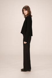 Side view of woman wearing a black cardigan 