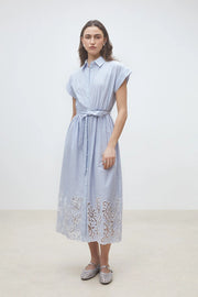 Woman wearing a light blue pinstripe short-sleeve shirt dress with a belted waist and embroidered hem, front view