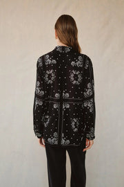 Back view of woman wearing a bandana-patterned button down blouse