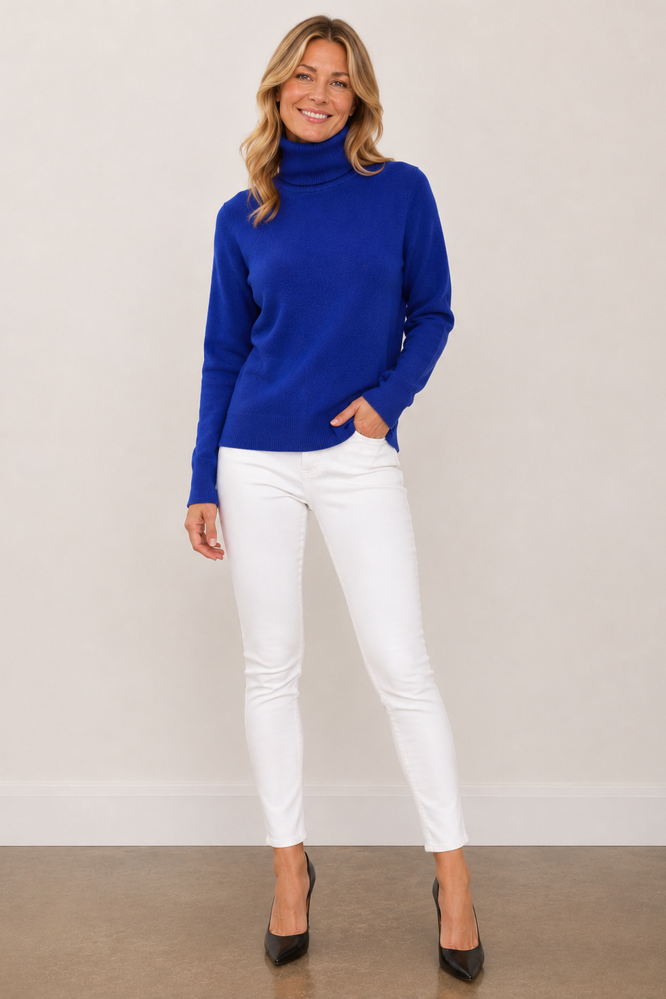 A woman modeling a bright royal blue turtleneck sweater.