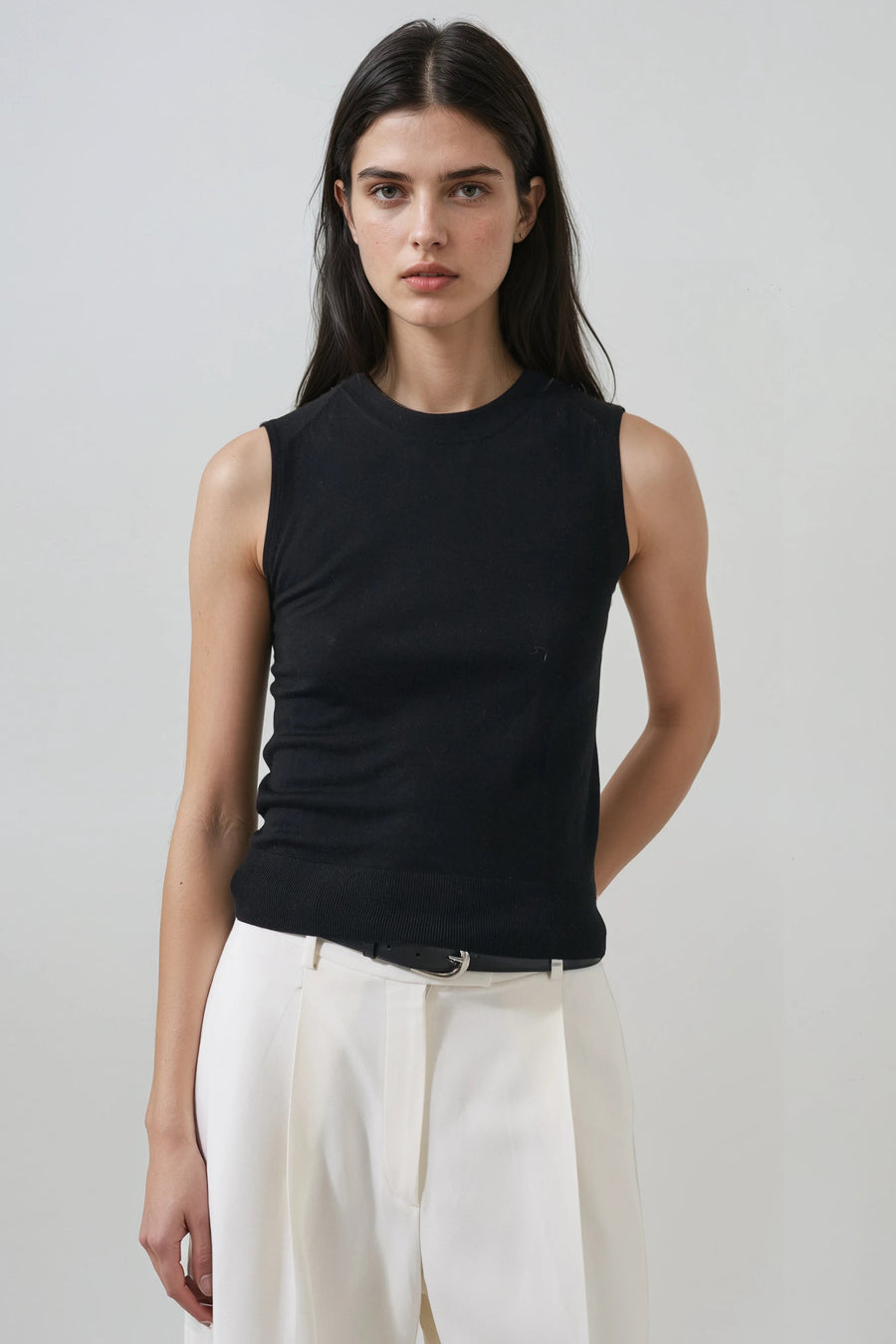 model wearing black sleeveless top with a crew neckline 