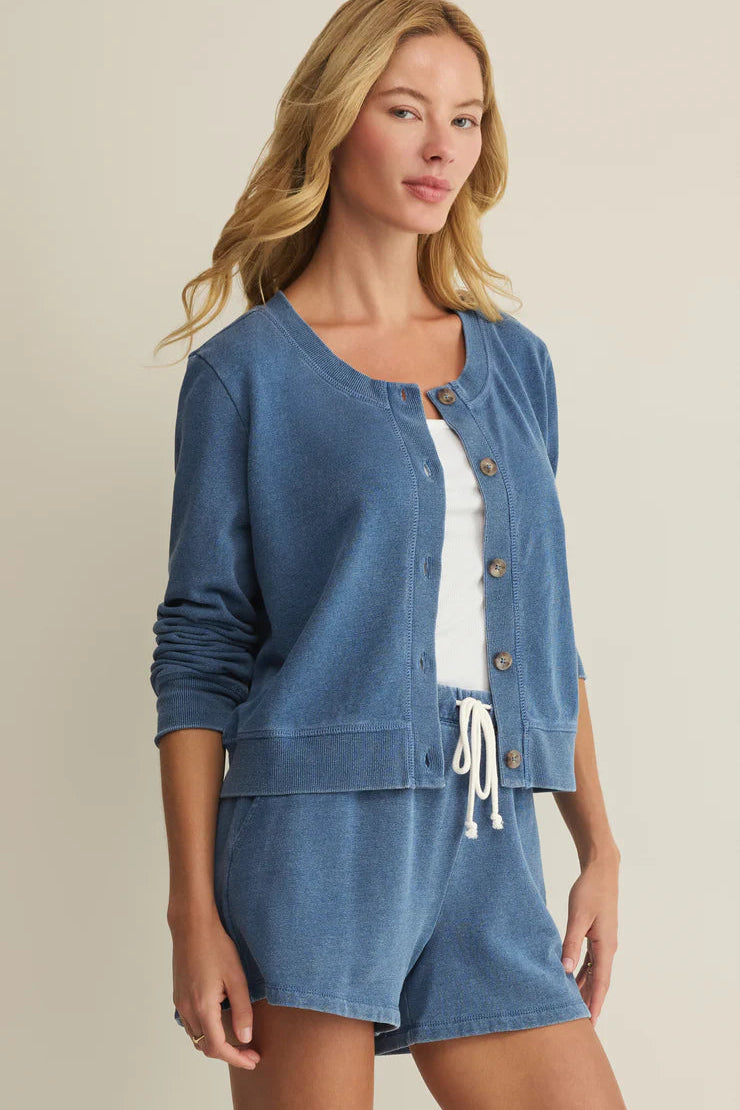 Woman wearing a blue long-sleeve button-front cardigan with a relaxed fit, side