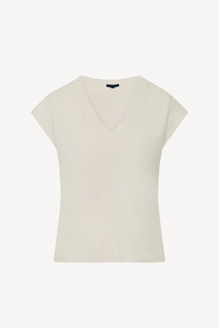 Woman wearing a cream V-neck short-sleeve top with a relaxed fit, front view