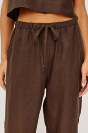 Woman wearing brown wide-leg drawstring pants with an elastic waistband, detail