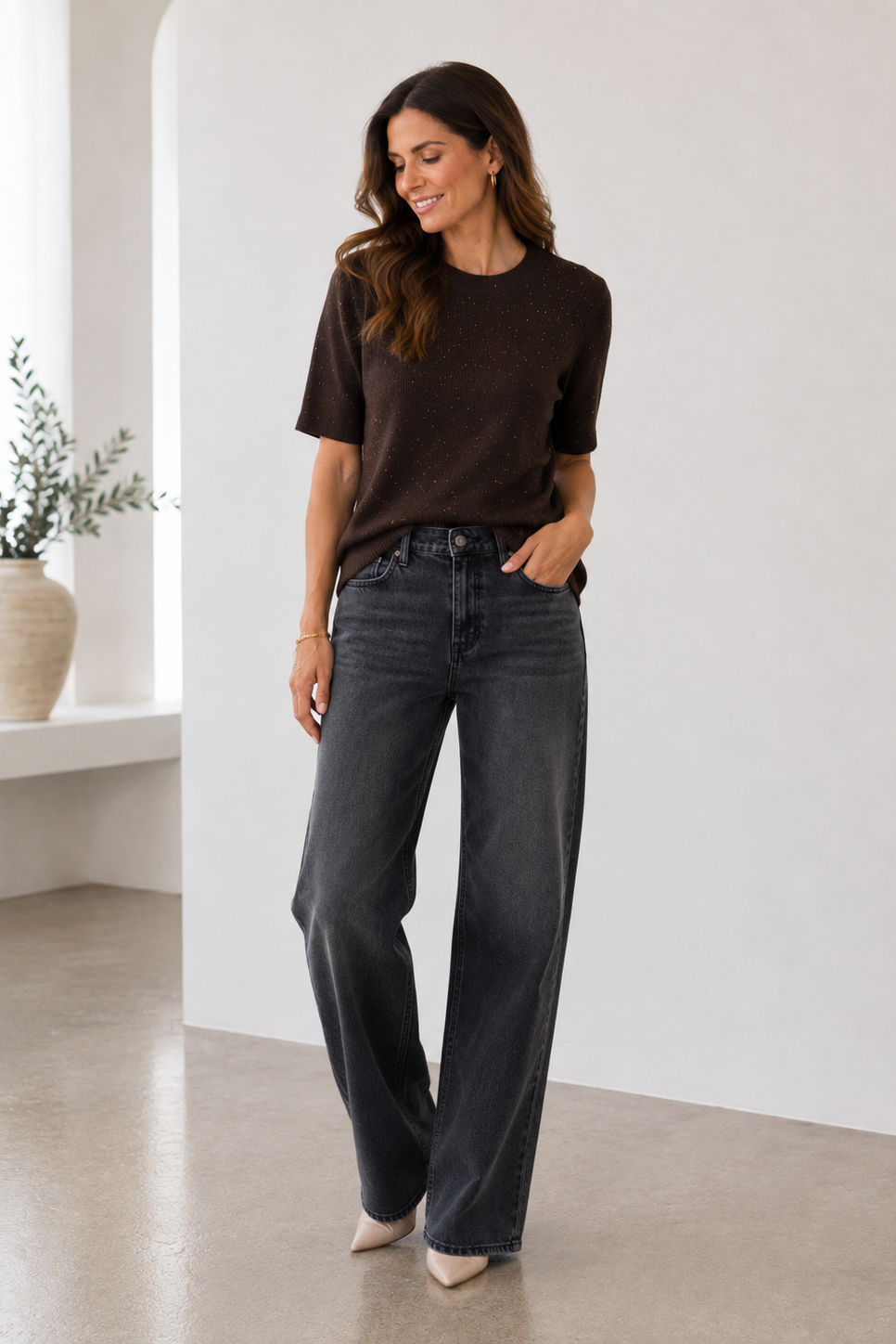 A woman modeling a dark brown short-sleeve knit top
