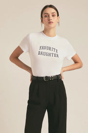 Woman wearing a fitted white graphic t-shirt with “Favorite Daughter” lettering and rolled short sleeves, front