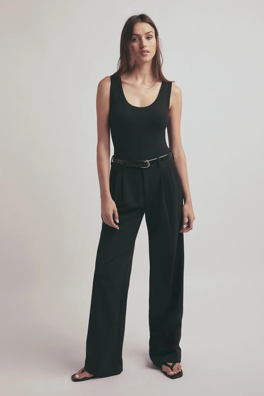 woman wearing a black belt with a silver coloured buckle