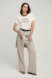 Woman wearing a white t-shirt with text 