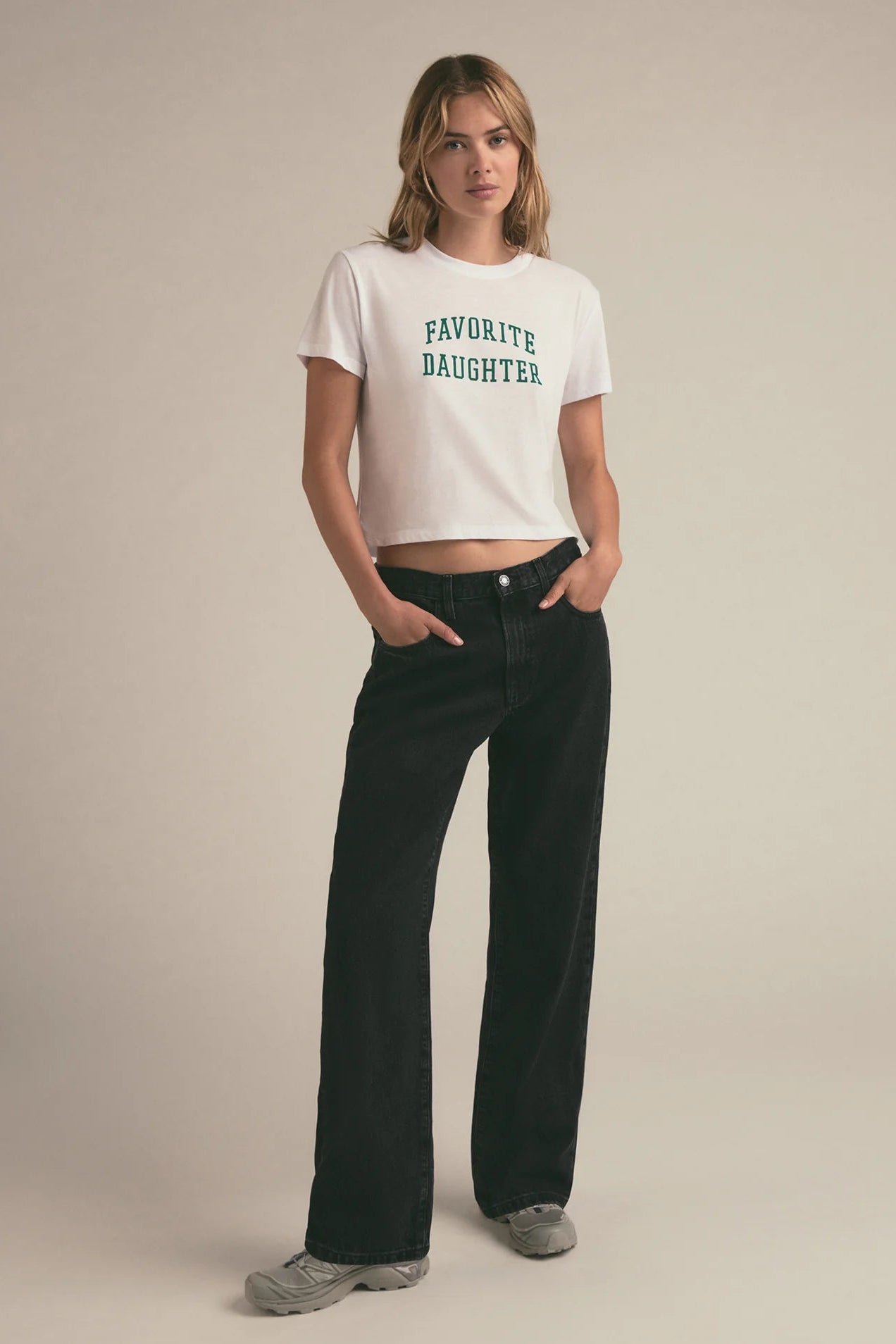 Woman wearing a graphic cropped tee that reads "FAVORITE DAUGHTER"