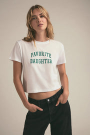 Woman wearing a graphic cropped tee that reads "FAVORITE DAUGHTER"