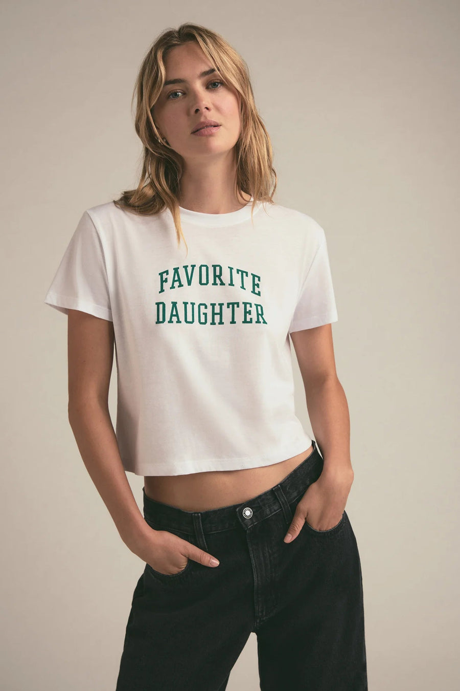 Woman wearing a graphic cropped tee that reads "FAVORITE DAUGHTER"