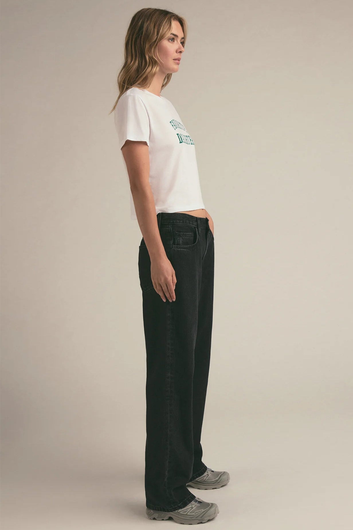 Side profile of a woman wearing a graphic cropped tee that reads "FAVORITE DAUGHTER"