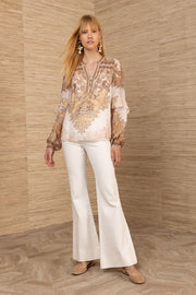 Woman wearing a paisley patterned blouse 