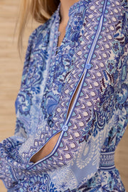 Close-up of a blue patterned long sleeve short dress