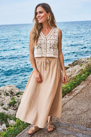 A-line maxi skirt with a slit, side pockets, and an elastic waistband with a drawstring.