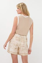 Shorts in a safari print featuring front pockets, a drawstring and elastic waistband, and faux welt pockets at the back. 