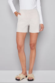 Woman wearing beige shorts with subtle stripes