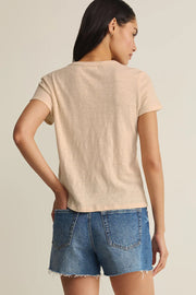 Woman wearing a beige crewneck short-sleeve T-shirt, back