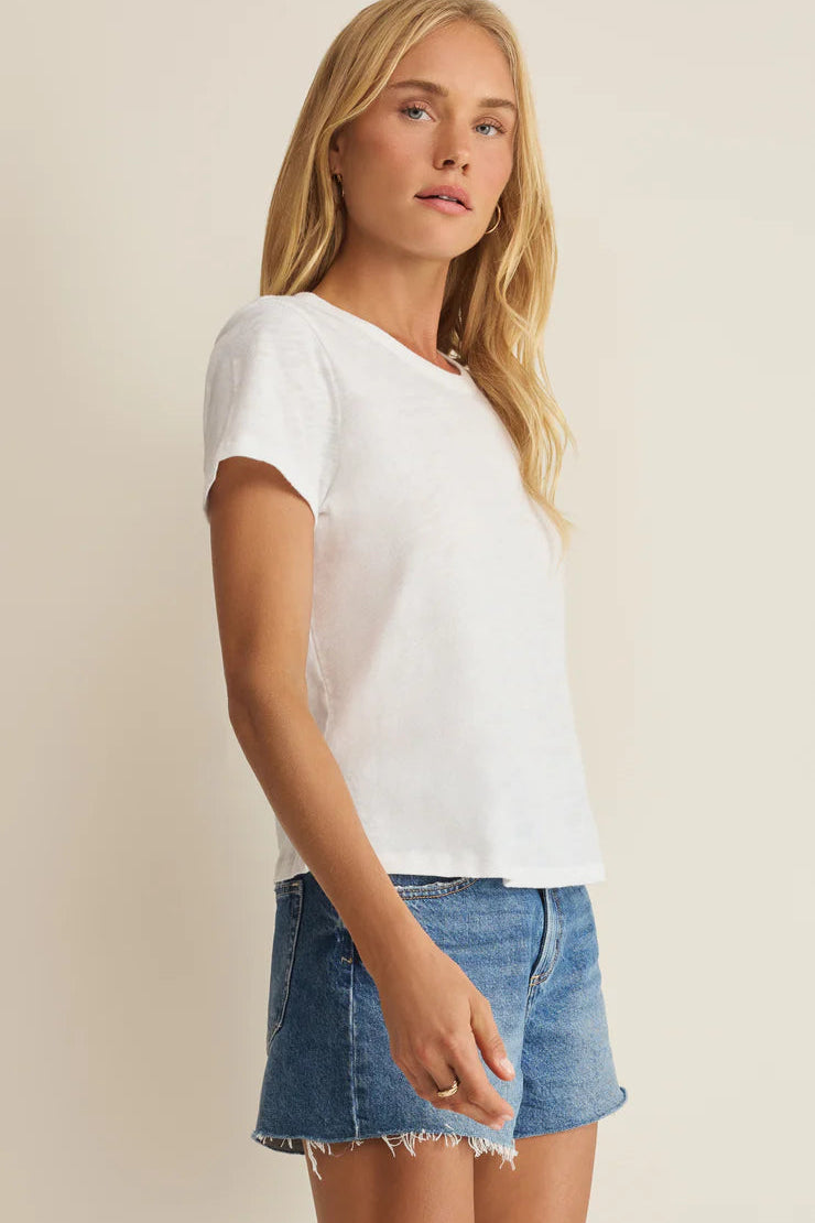 Woman wearing a white crewneck short-sleeve T-shirt, side