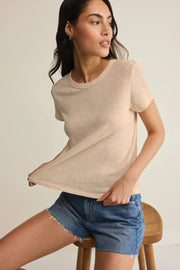 Woman wearing a beige crewneck short-sleeve T-shirt, front