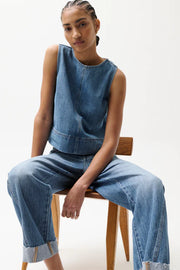 Woman wearing light wash straight-leg jeans with a cuffed hem