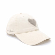 Cream baseball cap with a textured heart detail and “love always” embroidery on the side, side view
