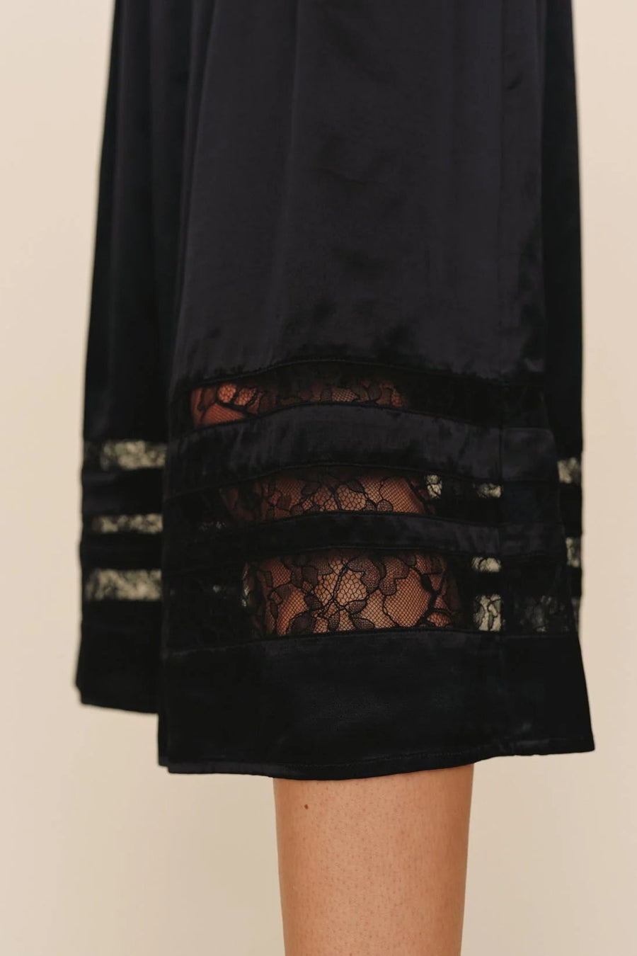 close up of a black a-line inset lace midi skirt