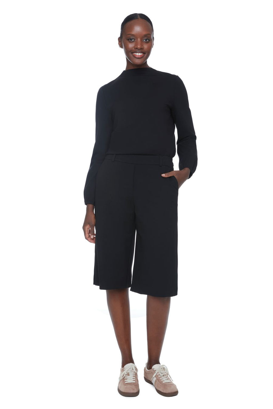 Women wearing long black wide-leg shorts 