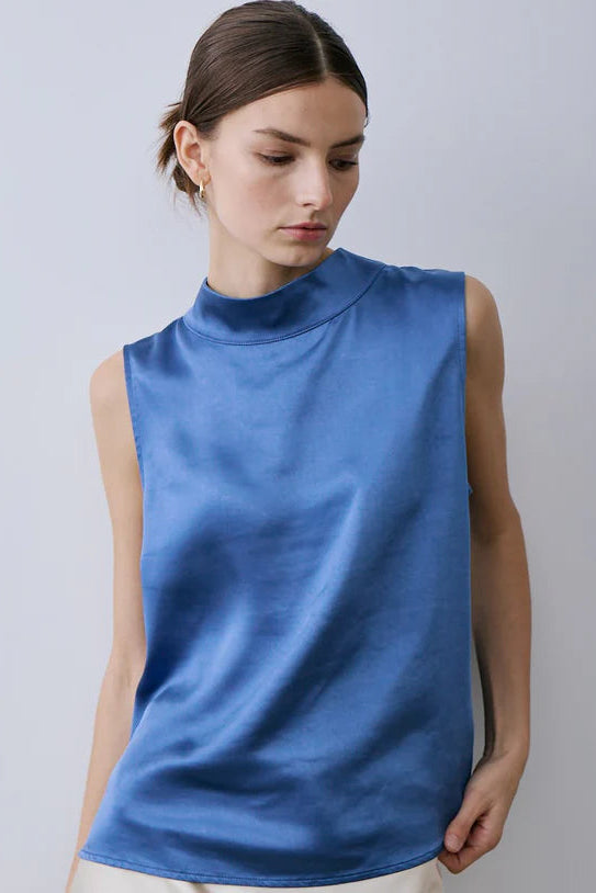 woman wearing blue satin mock-neck tank top