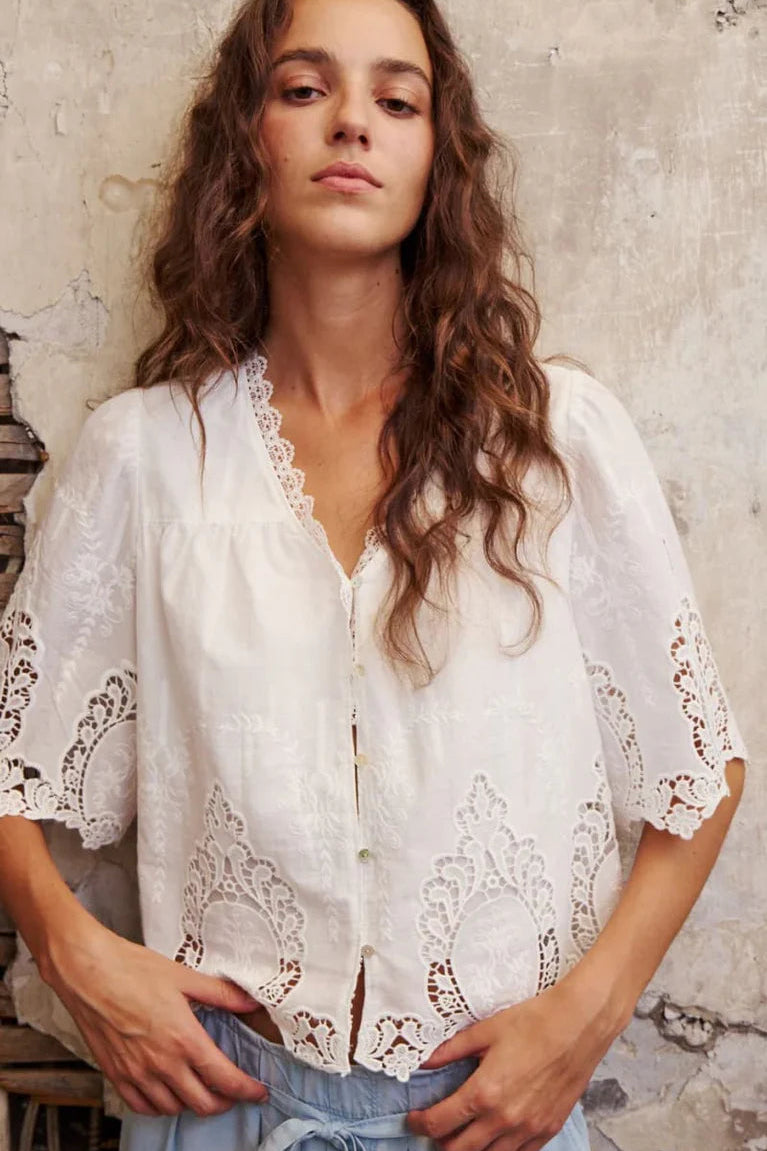 woman wearing a off white button down blouse